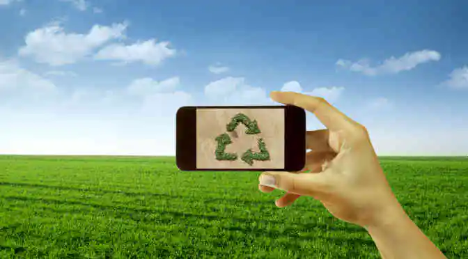 Recycling concept icon on smartphone screen held by hand