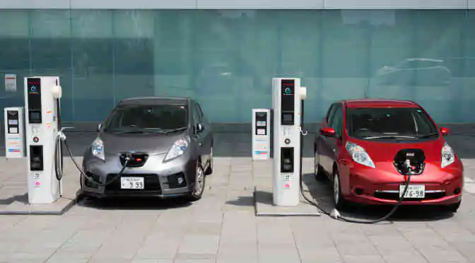 Electric vehicles being charged at charging stations